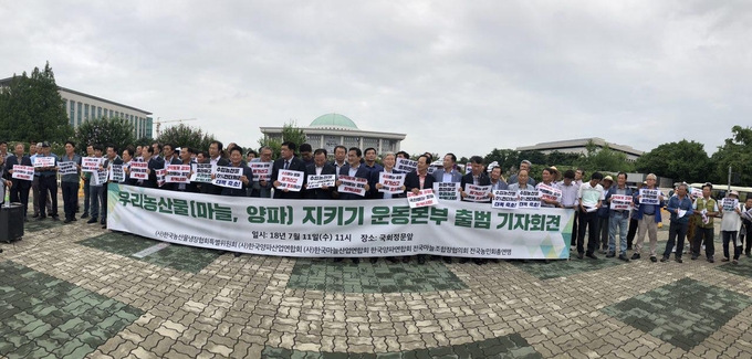우리농산물(양파,마늘)지키기 운동본부 출범 기자회견이 7월 11일 국회정문앞에서 (사)한국농산물냉장협회 특별위원회, (사)한국양파산업연합회, (사)한국마늘산업연합회, 한국양파연합회, 전국마늘조합장협의회, 전국농민회총연맹 등이 참석한 가운데 열리고 있다. 나아름 kenews.co.kr